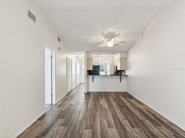 unfurnished living room featuring dark hardwood / wood-style floors and ceiling fan