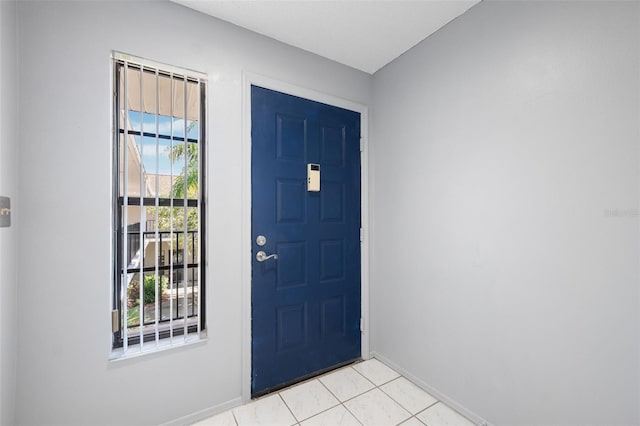 foyer entrance featuring light tile patterned floors