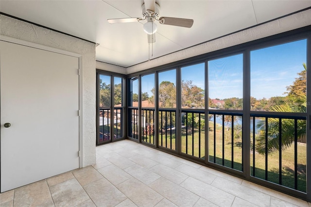 unfurnished sunroom featuring ceiling fan