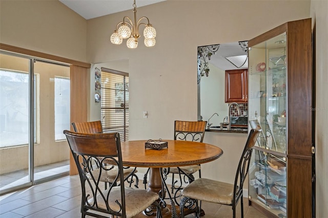 dining area featuring light tile patterned floors and an inviting chandelier