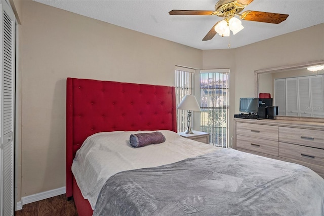 bedroom featuring dark hardwood / wood-style flooring, a closet, and ceiling fan