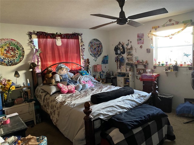 bedroom featuring carpet, a textured ceiling, and ceiling fan