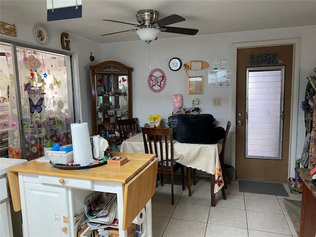 tiled dining room featuring ceiling fan