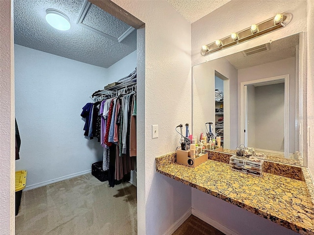 bathroom with a textured ceiling and vanity