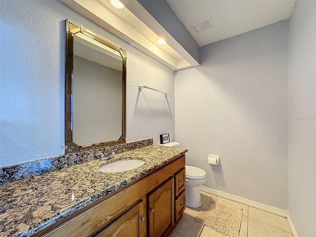 bathroom featuring toilet, tile patterned floors, and vanity