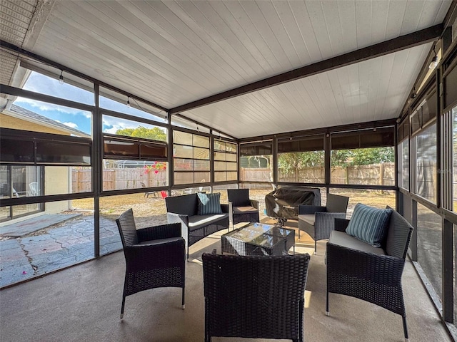 sunroom / solarium with a healthy amount of sunlight and lofted ceiling