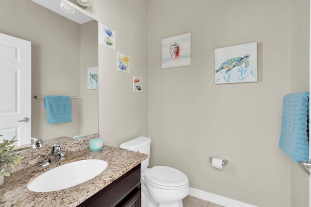 bathroom featuring tile patterned floors, vanity, and toilet