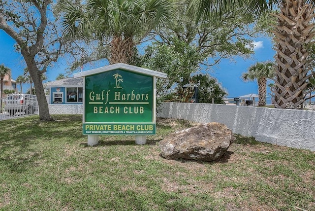 community / neighborhood sign with a lawn