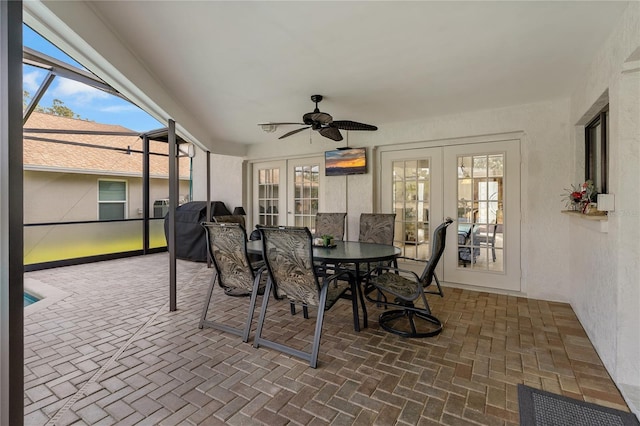 sunroom with ceiling fan and french doors