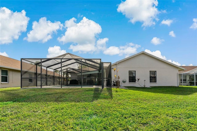 back of house with glass enclosure and a lawn