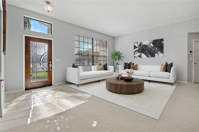 living room featuring light tile patterned flooring and a textured ceiling