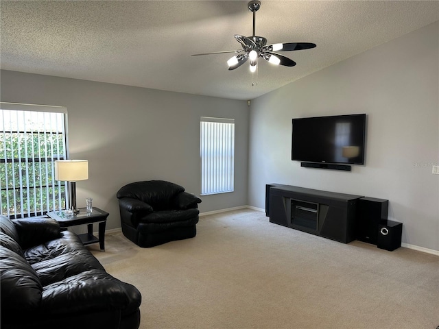 carpeted living room with ceiling fan, lofted ceiling, and a textured ceiling