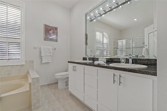 full bathroom featuring independent shower and bath, vanity, tile patterned floors, and toilet