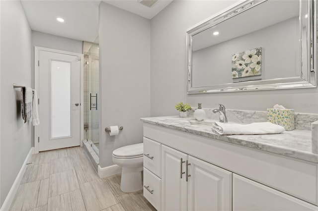 bathroom with vanity, an enclosed shower, and toilet