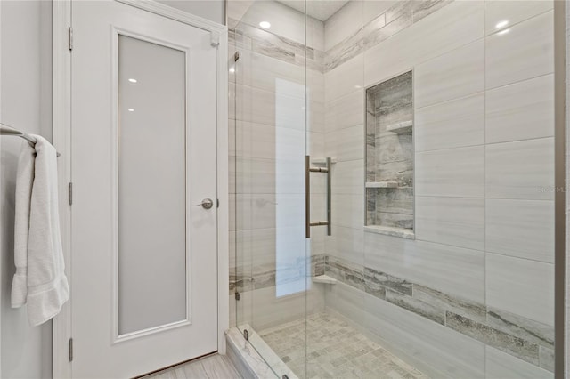 bathroom featuring a shower with shower door