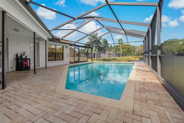 view of pool with a patio and glass enclosure