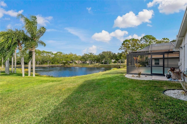 view of yard featuring a water view and glass enclosure