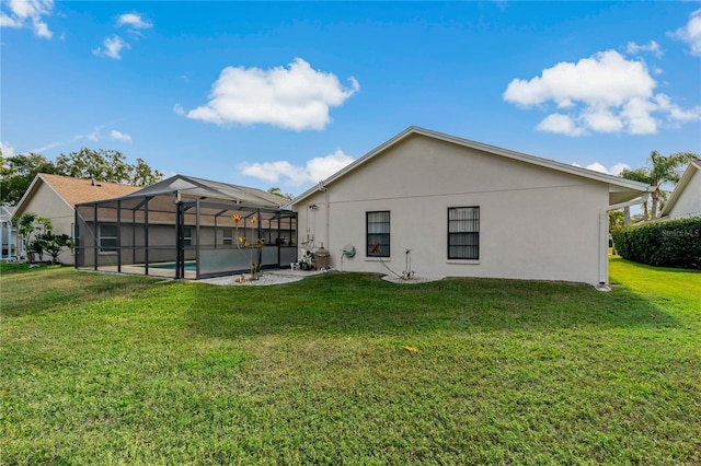 back of property with a lanai and a lawn