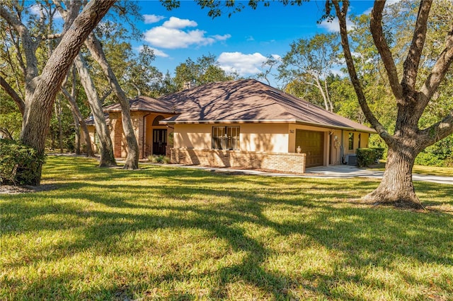 ranch-style house with a garage and a front lawn