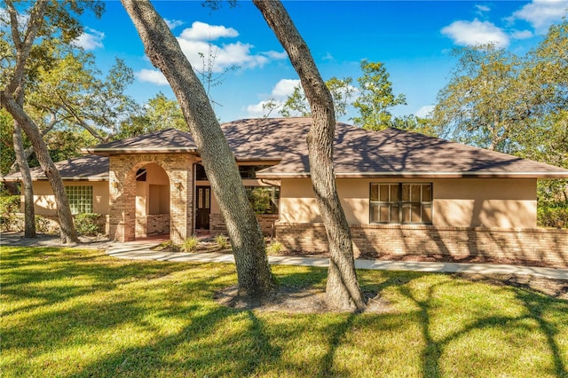7443 Oak Tree Ln, Spring Hill, FL 34607 - view of front facade with brick siding and a front lawn