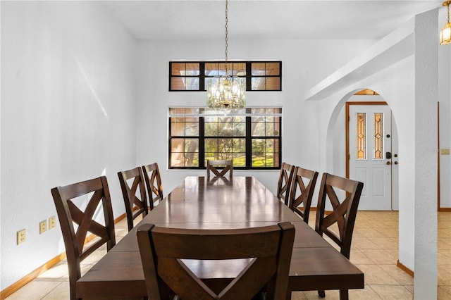 tiled dining area with a notable chandelier