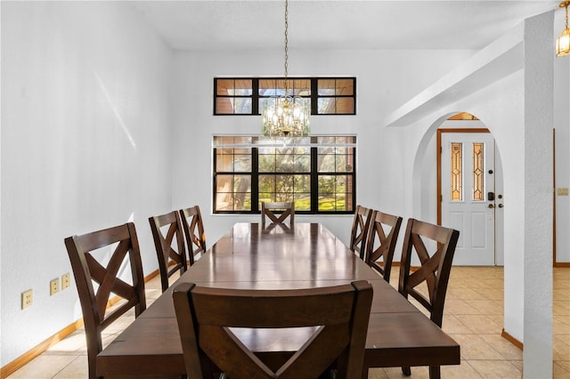 7443 Oak Tree Ln, Spring Hill, FL 34607 - dining area featuring a chandelier, arched walkways, and light tile patterned floors