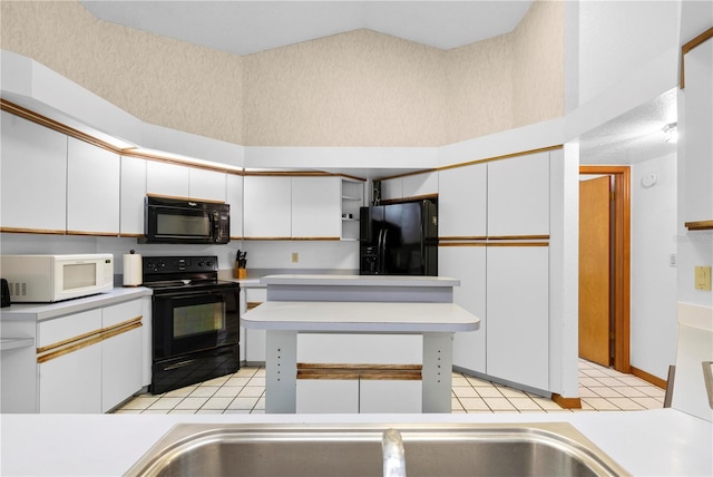 7443 Oak Tree Ln, Spring Hill, FL 34607 - kitchen with black appliances, white cabinets, and light countertops