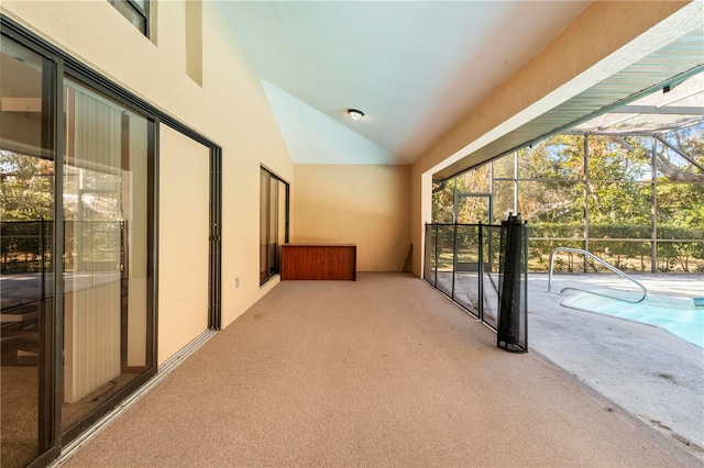 hall with light carpet and high vaulted ceiling