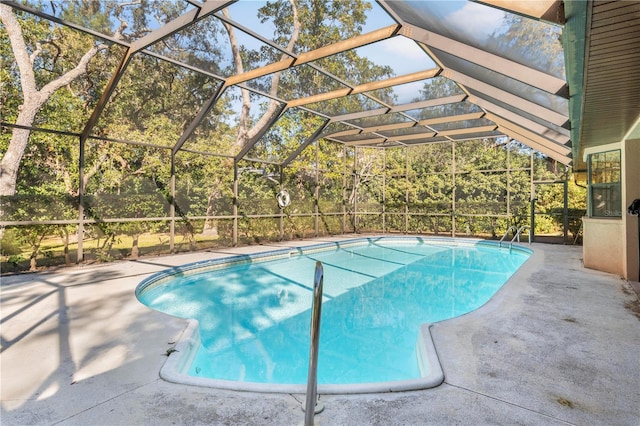 view of swimming pool with a patio and a lanai