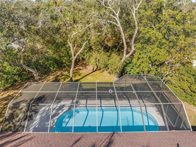 view of swimming pool featuring a lanai