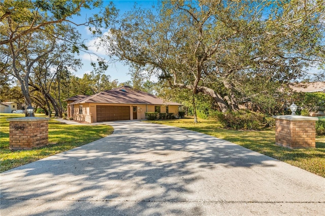 view of front of property featuring a front yard and a garage