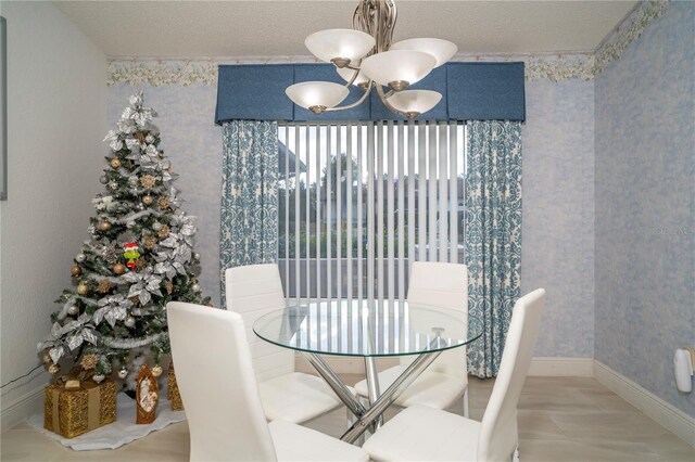 dining room featuring a textured ceiling and a chandelier