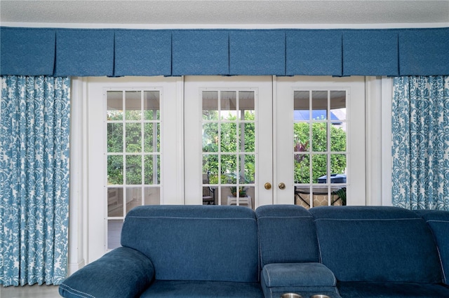 exterior space with french doors and a textured ceiling