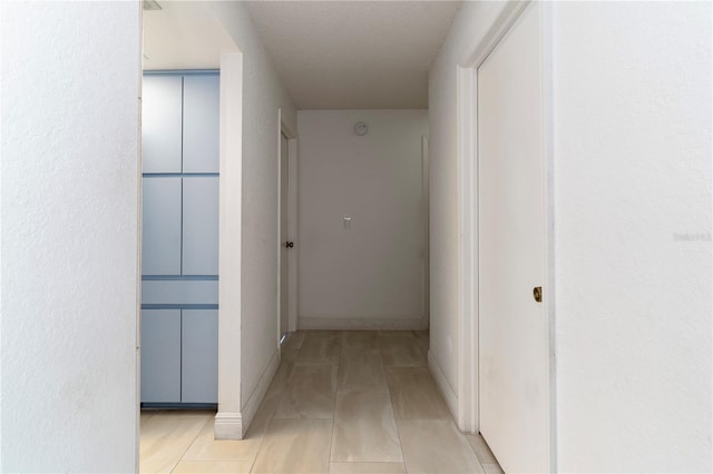 hallway with light tile patterned floors