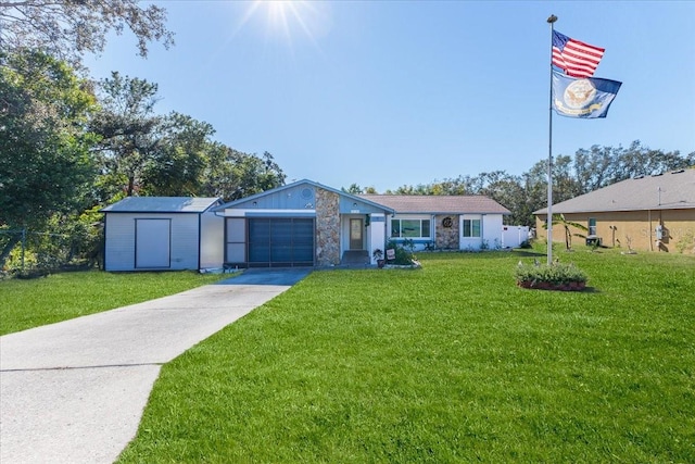 single story home featuring a front lawn and a garage