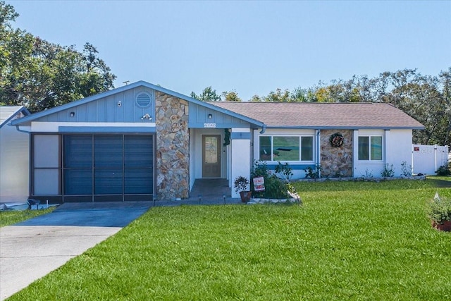 ranch-style house with a garage and a front yard