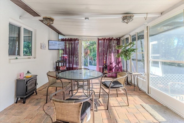 sunroom / solarium with a wood stove