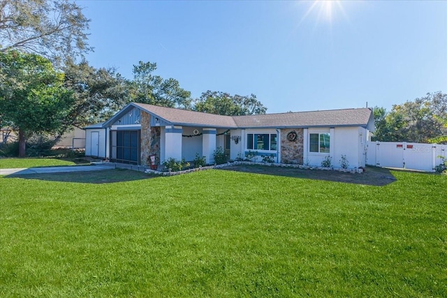 single story home featuring a garage and a front lawn