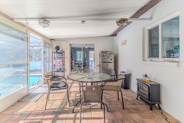 sunroom / solarium featuring beamed ceiling