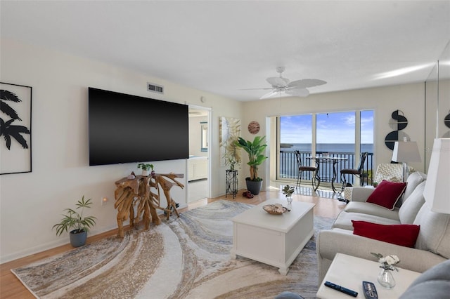 living room featuring ceiling fan and light hardwood / wood-style flooring