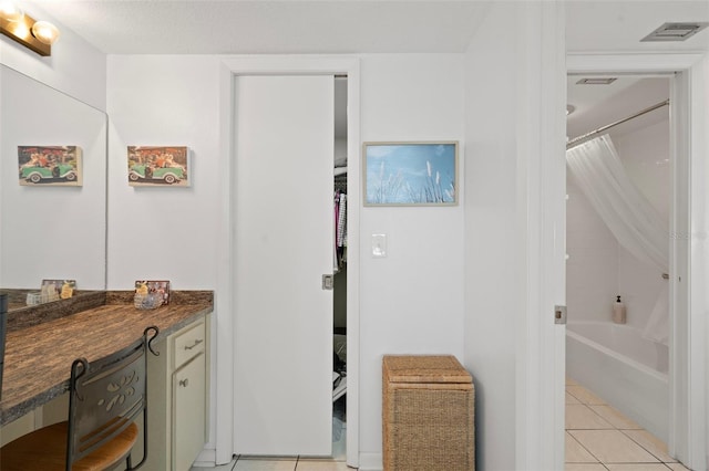 bathroom featuring tile patterned flooring and vanity