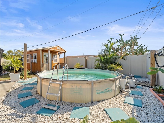 view of pool featuring an outbuilding