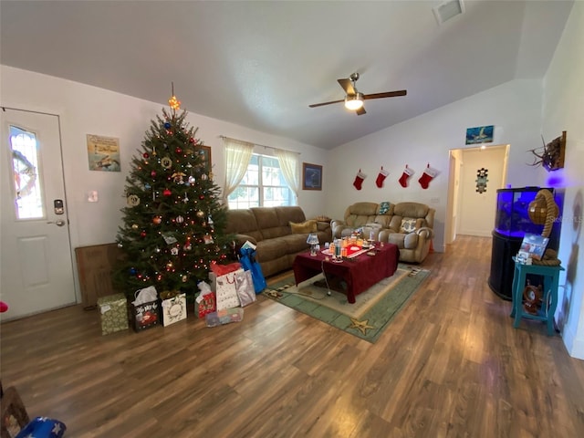 living room featuring dark hardwood / wood-style flooring, vaulted ceiling, and ceiling fan