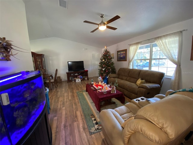 living room featuring ceiling fan, lofted ceiling, and dark wood-type flooring