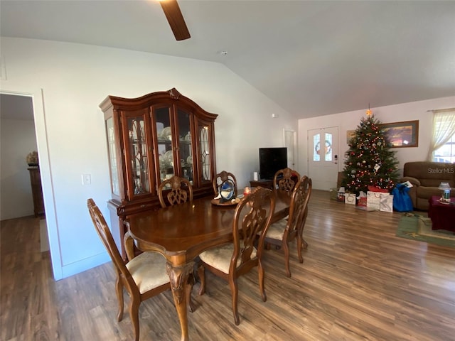 dining space featuring dark hardwood / wood-style floors, vaulted ceiling, and ceiling fan