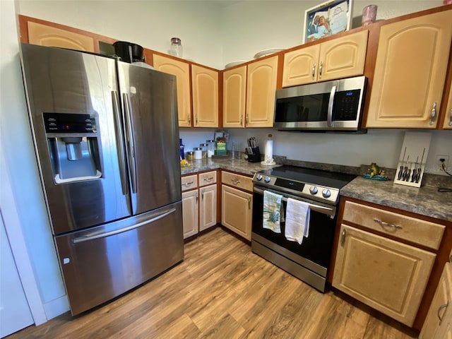 kitchen featuring stainless steel appliances and hardwood / wood-style flooring