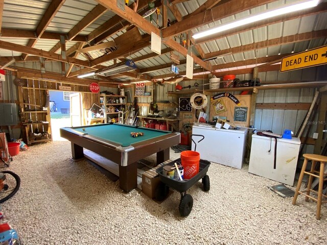 recreation room with wooden walls, lofted ceiling with beams, billiards, washer / dryer, and carpet floors