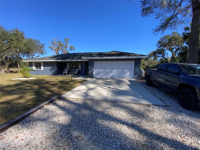 ranch-style house featuring a front yard and a garage