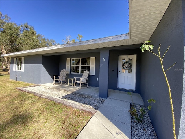 property entrance featuring covered porch