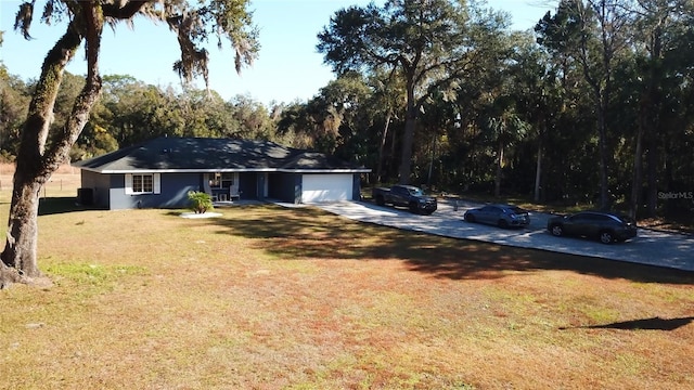 exterior space with a garage and a front lawn